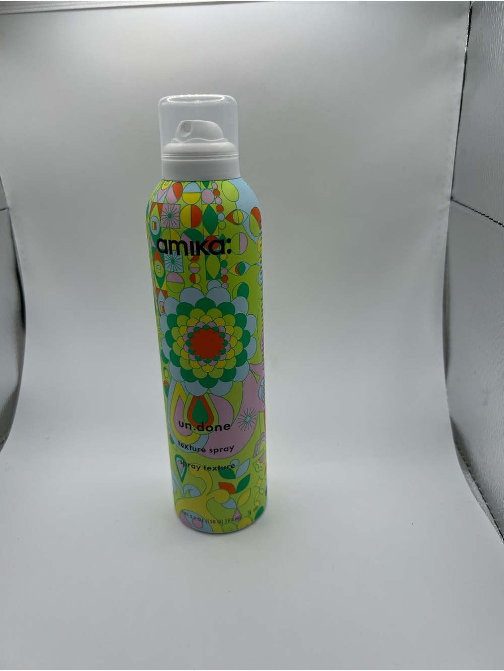 amika undone Texture Spray in green and pink floral can